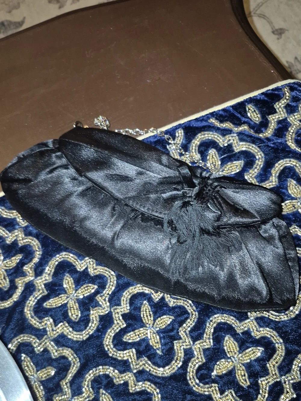 Vintage: A black satin foldover evening bag. Satin Bow& Rusch Pleating &tassels